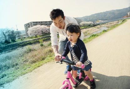 father and daughter biking