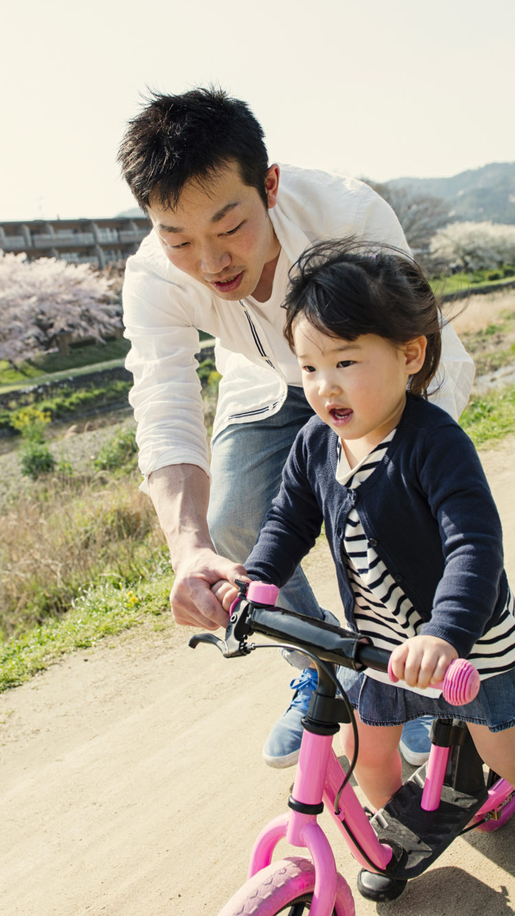 father and daughter biking