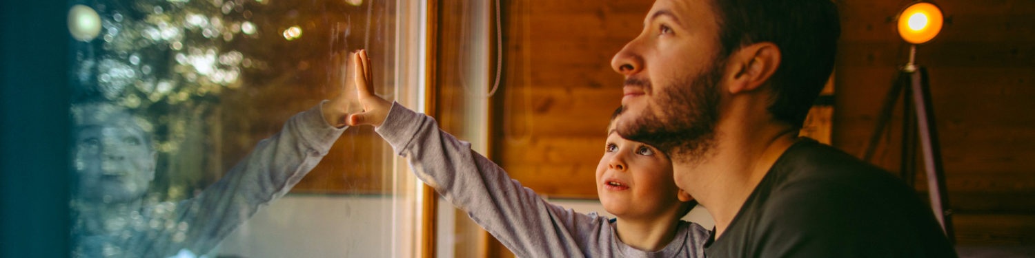 Dad and child at window