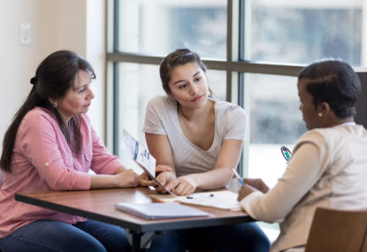 3 people meeting around a table